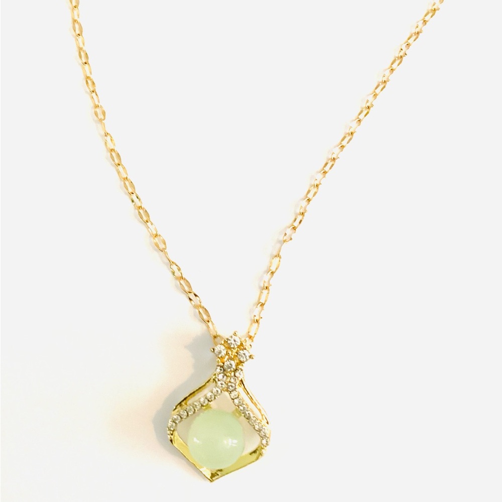 stunning green stone pendant necklace, surrounded by fashion diamonds.